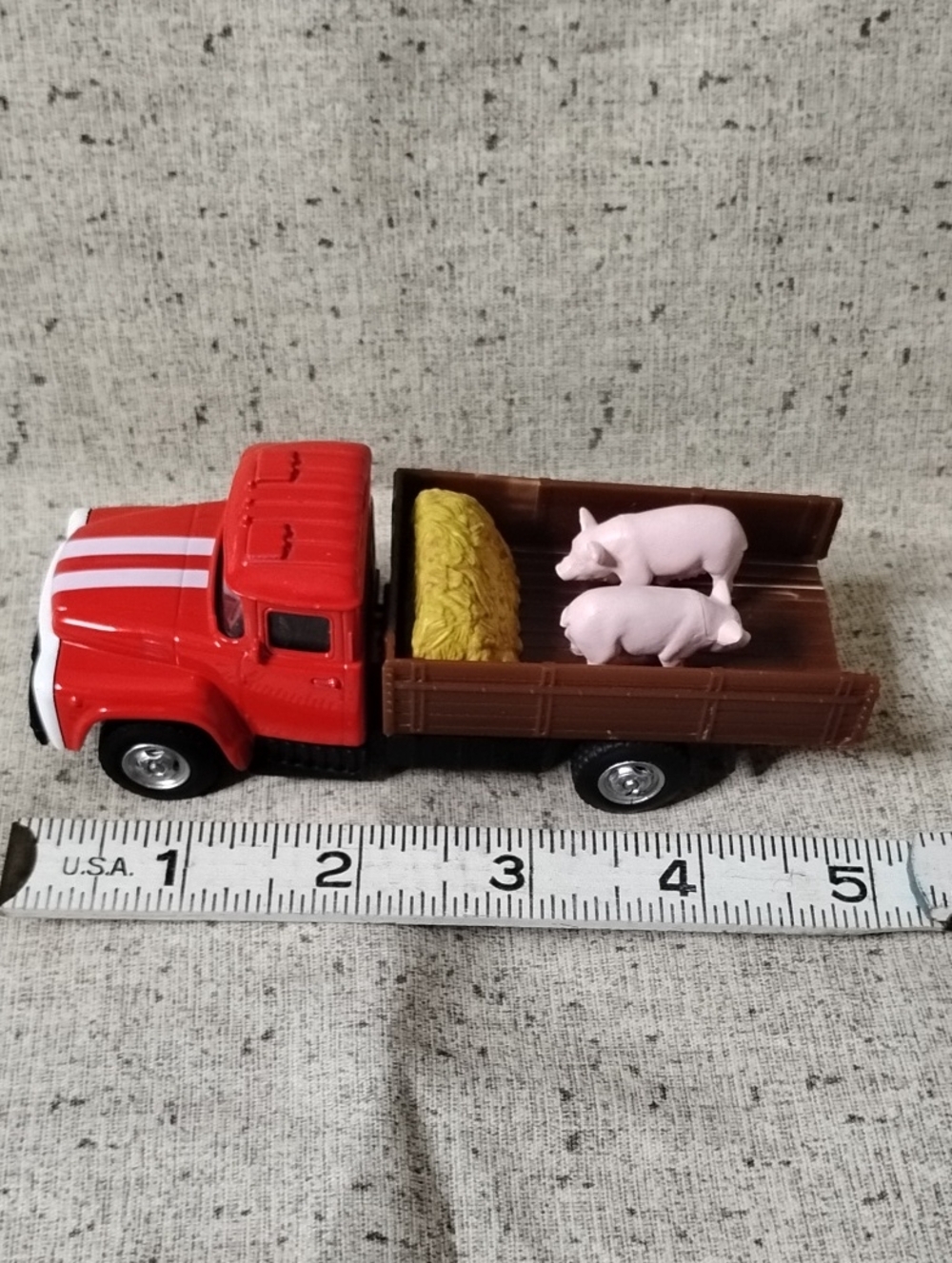 Red Toy Pickup Truck with Brown Bed and Pink Pig Figures